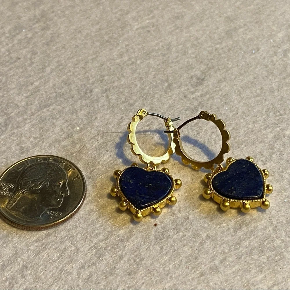 Tory Burch blue lapis heart drops hanging from huggie hoops.